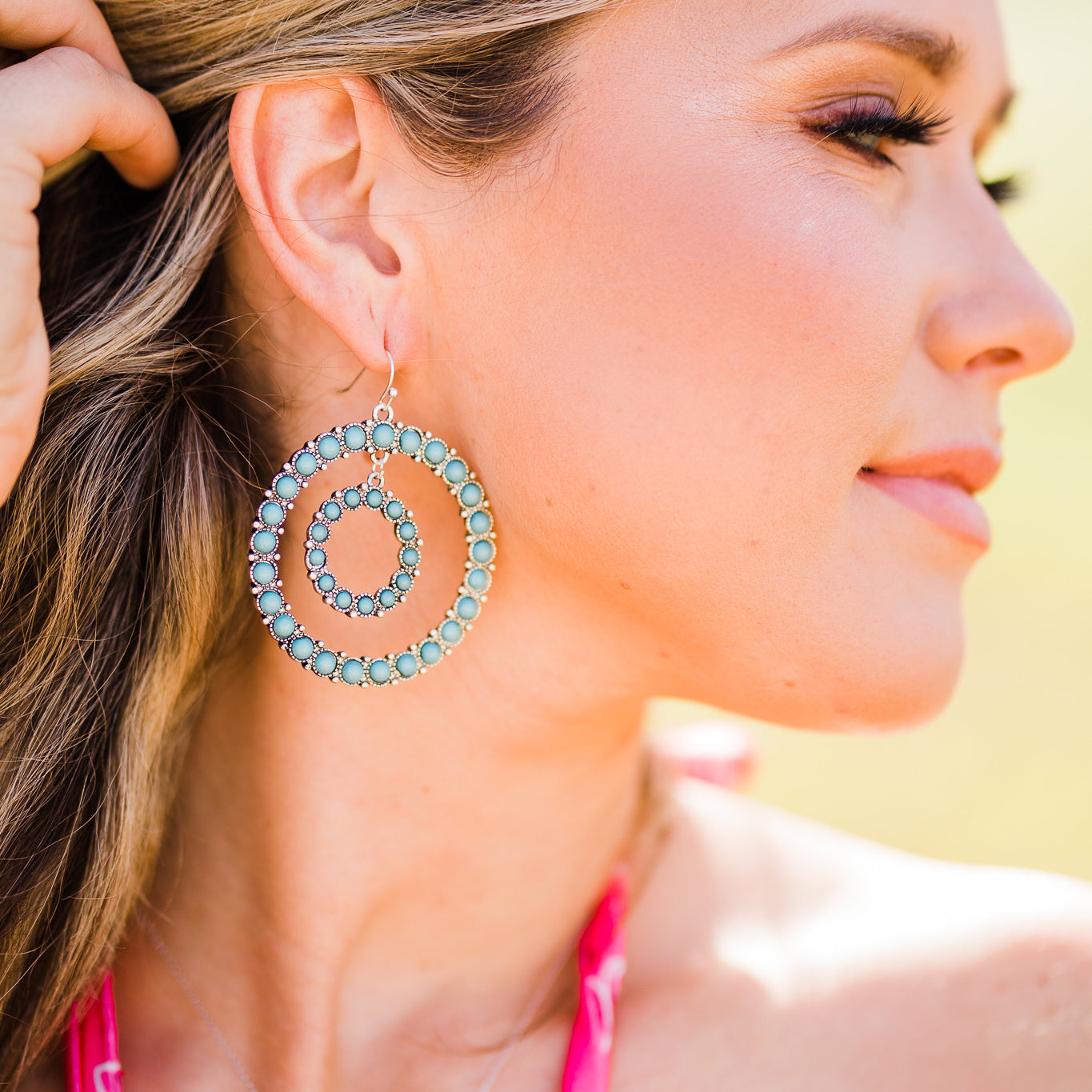 model wearing western style earrings