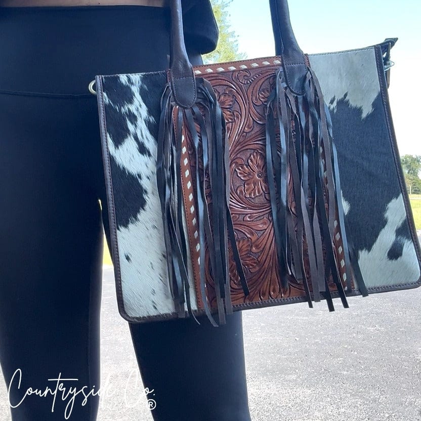 model posing with Countryside Co western style handbag on her arm