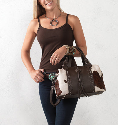 model posing with American West western style handbag on her arm
