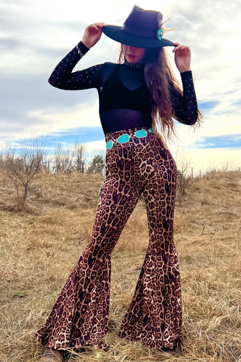 model wearing sterling kreek leopard print bells in a grassy hillside scene