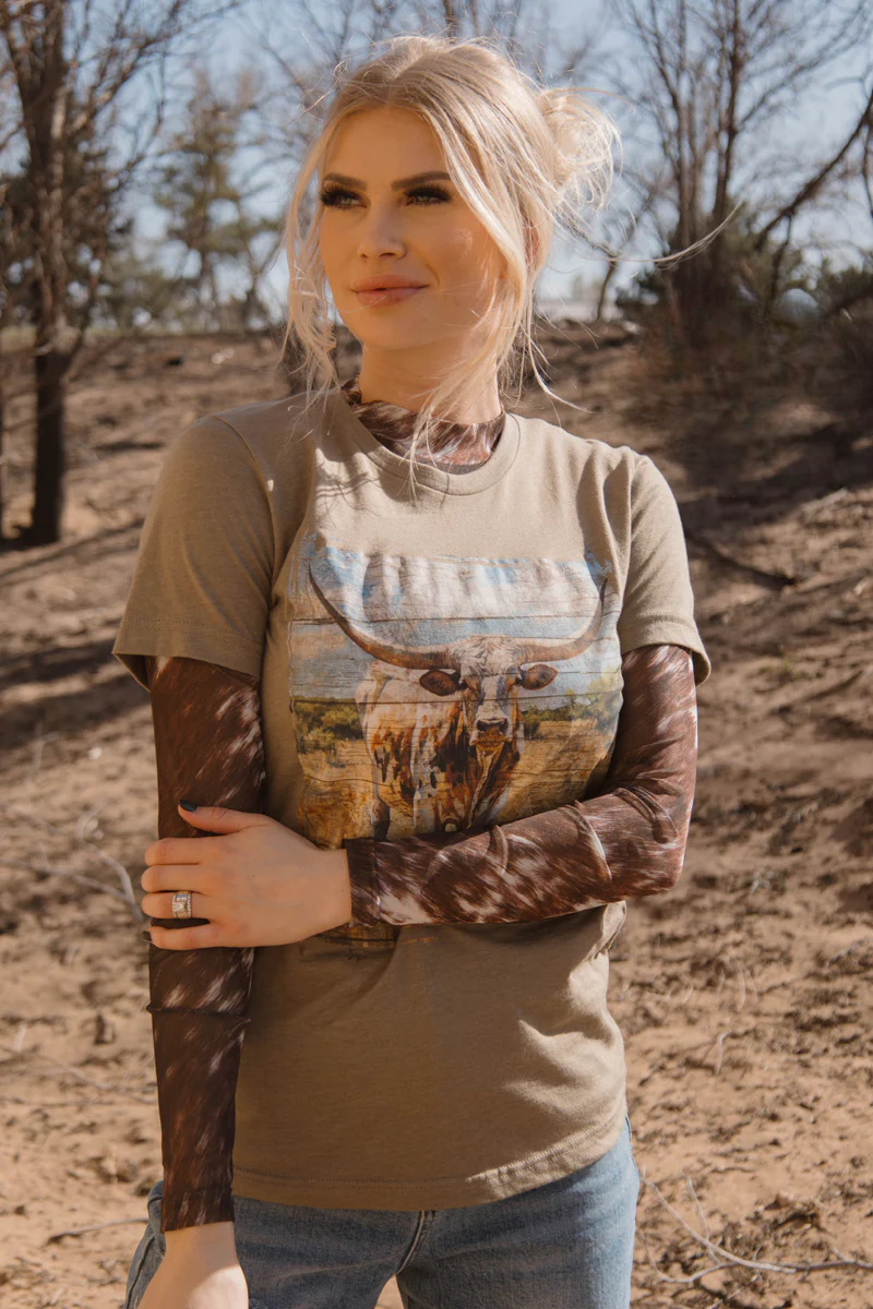 model wearing the barnwood boss graphic tee standing in a wooded scene